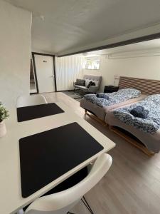 a room with two beds and a table and chairs at H. C. Lumbyes Vej - kælderlejlighed in Odense