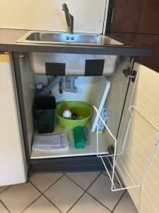 a sink in a kitchen with a bowl under it at H. C. Lumbyes Vej - kælderlejlighed in Odense +17 photos