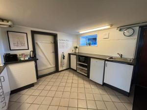 a kitchen with a sink and a counter top at H. C. Lumbyes Vej - kælderlejlighed in Odense