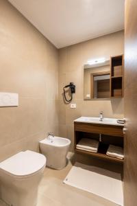 a bathroom with a toilet and a sink at Park Hotel Gemona in Gemona del Friuli +4 photos