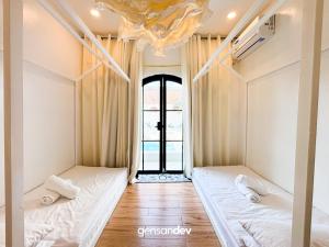 two beds in a room with a window at White Villa in General Santos +23 photos