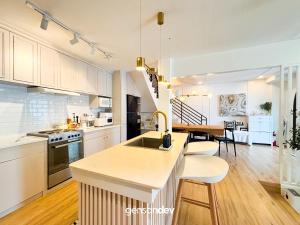 a kitchen with white cabinets and a counter top at White Villa in General Santos