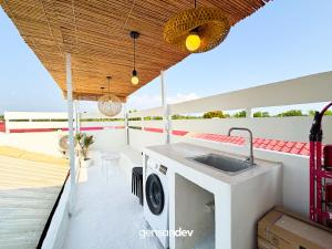 a balcony with a sink and a washing machine at White Villa in General Santos