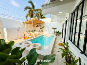 a swimming pool in the middle of a house at White Villa in General Santos