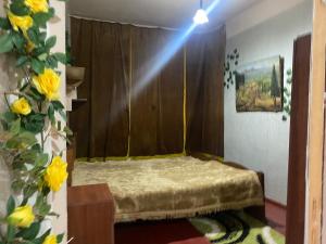 a bedroom with a bed with a wooden wall at Live as you are LOCAL in Tbilisi City