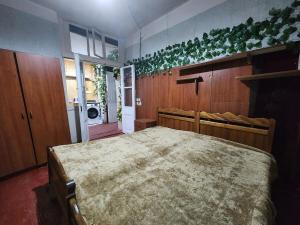 a bedroom with a large bed in a room at Live as you are LOCAL in Tbilisi City +8 photos