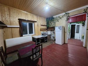 a room with a kitchen with a table and a refrigerator at Live as you are LOCAL in Tbilisi City