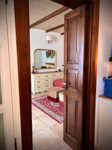 an open door to a bedroom with a mirror at Le Dimore al Castello in Massafra