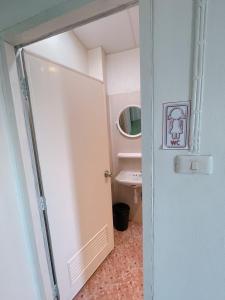 a bathroom with a white door and a sink at latitude 14 Room & breakfast in Ban Bang Sakae +26 photos