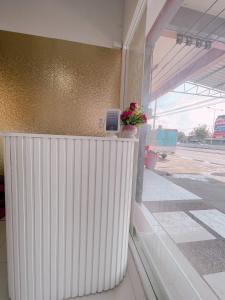 a counter with a flower pot on top of a building at latitude 14 Room & breakfast in Ban Bang Sakae