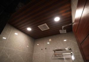 a bathroom with a ceiling with lights and a toilet at Sri Rama Grand in Chilakalūrupet