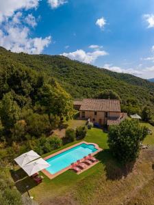 an aerial view of a house with a swimming pool at Fattoria La Striscia in Gambassi Terme