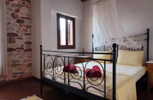 a bedroom with a bed with red roses on it at Alexis new villas in Chrysi Ammoudia