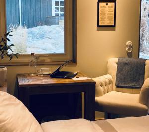 a bedroom with a desk with a laptop on it at Gottskär Hotell & Konferens in Onsala