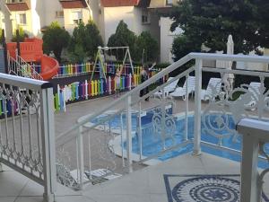 a swimming pool with a slide in a playground at Hotel Panorama in Sveti Vlas