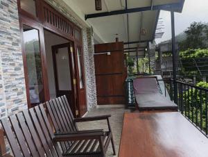 a porch with two chairs and a bench on a balcony at SEENBEST Ella in Ella +58 photos