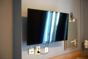 a flat screen tv hanging on a wall at Electra Hotel Piraeus in Piraeus +40 photos
