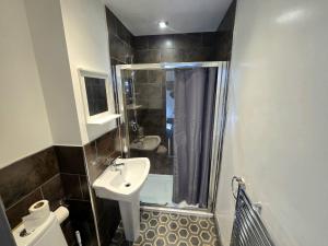 a bathroom with a shower and a sink and a toilet at Church Views in Burnley +9 photos