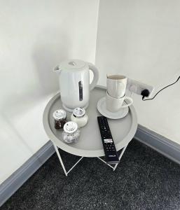 a table with a coffee maker and cups on it at Church Views in Burnley