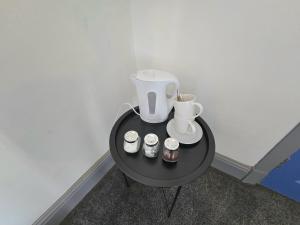 a black table with a blender and three jars on it at Church Views in Burnley