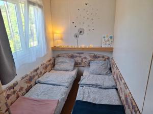 a room with a couch with pillows and a window at Lexi Zen House in Kamnik