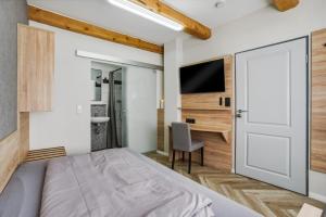 a bedroom with a bed and a desk at Altstadt Pension Vlotho in Vlotho +53 photos