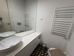 a white bathroom with a sink and a toilet at Alfama Premium in Lisbon +16 photos