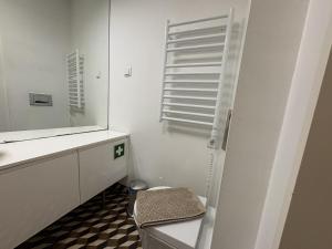 a bathroom with a sink and a toilet and a mirror at Alfama Premium in Lisbon