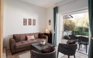 a living room with a couch and chairs at Megusta Apartments Selianitika - Poolside Escape in Selianitika