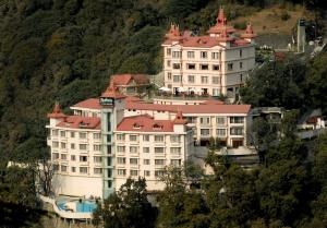 a large building on the side of a mountain at Radisson Hotel Shimla in Shimla