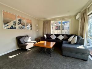 a living room with a couch and a table at Hanmer Time in Hanmer Springs