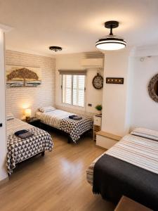 a hotel room with three beds and a window at Villa Filipinas ,CITY CENTER -ETV10310 in Palma de Mallorca +49 photos