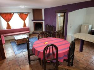a room with a table and chairs and a fireplace at Turinjandi in Zirahuén +4 photos