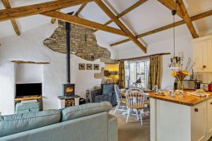 a living room with a couch and a table at Cobble Cottage in Cardinham
