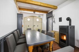 a dining room with a table and a fireplace at Altstadt Pension Vlotho in Vlotho