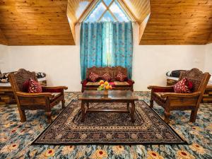a living room with a couch and two chairs and a table at Water Vibe Homestay Srinagar in Srinagar