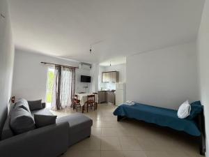 a living room with a couch and a table at Villa Earta & Leo Ksamil in Ksamil