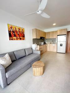 a living room with a couch and a kitchen at Mananero Group Residence in Cabarete