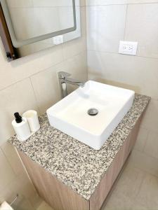 a white sink on a counter in a bathroom at Mananero Group Residence in Cabarete