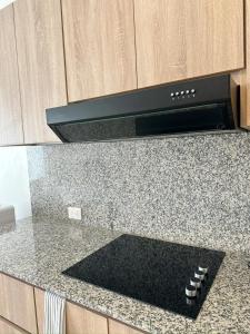 a kitchen counter with a black stove top oven at Mananero Group Residence in Cabarete +1 photo