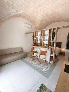 a living room with a couch and a table and chairs at Casa Gentile in Conversano