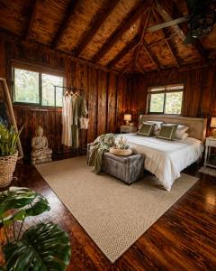 a bedroom with a bed in a room with wooden walls at Pipeline Tropical Bungalow in Haleiwa +8 photos