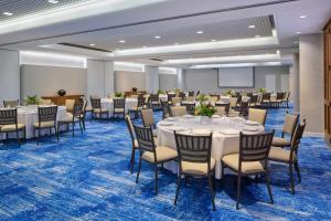 a conference room with tables and chairs and a projection screen at OUTRIGGER Reef Waikiki Beach Resort in Honolulu +181 photos