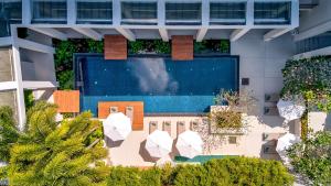 an overhead view of a building with a swimming pool at OUTRIGGER Surin Beach Resort in Surin Beach
