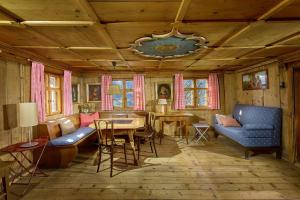 a living room with blue chairs and a table at Chalet Alte Mühle in Bartholomäberg