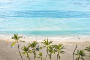 an overhead view of a beach with palm trees and the ocean at OUTRIGGER Waikiki Beach Resort in Honolulu +130 photos