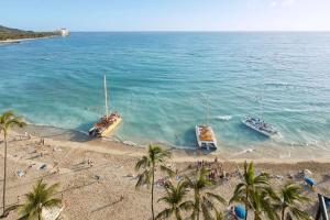 two boats in the water on a beach at OUTRIGGER Waikiki Beach Resort in Honolulu