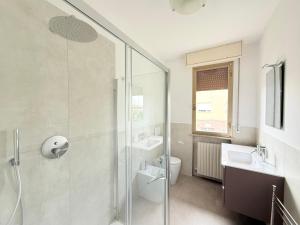 a bathroom with a shower and a toilet and a sink at SE148 - Marotta, trilocale con terrazzo e posto auto in Marotta +27 photos