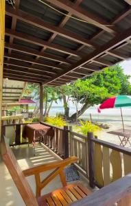 a balcony with a table and an umbrella at Henalric's Place in Caramay