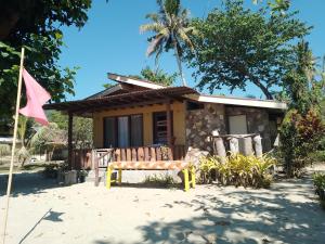 a house with a bench in front of it at Henalric's Place in Caramay +10 photos